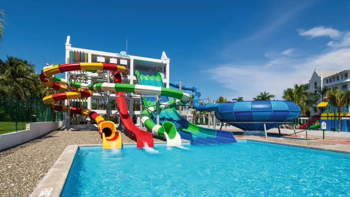 Colourful water slides splashing into a bright blue pool at the Splash water park